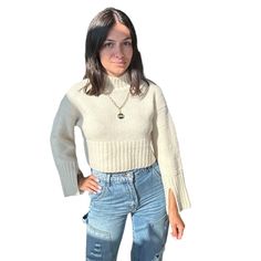 Embrace a playful yet chic look with our Cropped Bell Sleeve Sweater. Its cropped cut and bell sleeves make it perfect for pairing with high-waisted jeans or skirts. Ideal for adding a trendy touch to your wardrobe. Shop more Sweaters Model is wearing a small Shop more colors Cream Cropped Fuzzy texture Ribbed knit Sleeve slits Mock neck Thick rib knit trim 73% acrylic, 14% nylon, 10% wool, 3% spandex Still not sure which size to get? Ask one of our stylists! Please give us a call at 856-452-582 White Jumpsuit Dress, Fuzzy Texture, Bell Sleeve Sweater, Knit Sleeve, Denim Leggings, Short Rompers, Hair Accessories Headbands, Small Shop, Bell Sleeve