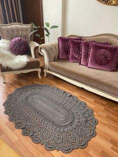 a living room with two couches and a rug on the floor in front of it