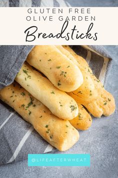 some bread sticks are in a bag on a gray and white striped towel with green sprinkles