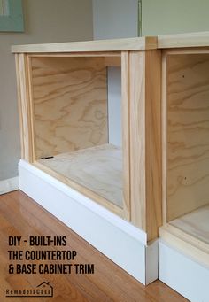 the bottom half of an unfinished cabinet is shown with text overlay that reads diy - built - ins the countertop and base cabinet trim