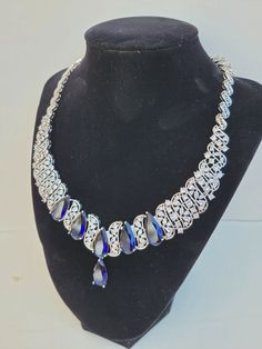 "Hello, welcome to Ken's Closet. 6 sapphires are set in this necklace. Sapphires are a dark blue. Today I have an amazing Fake Saphire and Diamond Necklace. The necklace is made of glass crystal embellishments. Crystal colors are blue and clear crystal. length is appx 17inch with the center drop being 1.5\". The necklace is in silver metal, I am just not sure what kind it is. The crystals are very sparkly in light, and will surely grab attention. This would be great for costumes, fancy dress, sa Crystal Colors, Blue Sapphire Necklace, Crystal Blue, Sapphire Necklace, Crystal Embellishment, Glass Crystal, Blue Bracelet, Diamond Crystal, Gold Set