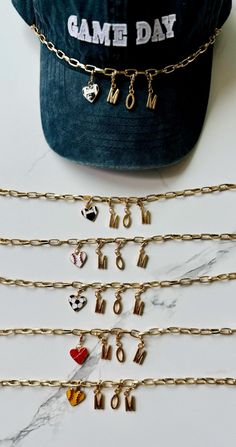 **Sports Mom Hat Chain & Charms - Elevate Your Style**    Choose From The Following: -Football Mom 🏈 -Baseball Mom ⚾️ -Soccor Mom ⚽️ -Basketball Mom 🏀 -Softball Mom 🥎 FREE SURPRISE HAT CHARM WITH EVERY PURCHASE!! Add a touch of elegance and uniqueness to your trucker hats with these stunning gold charms. Perfect for those who love to accessorize and stand out, these charms bring a chic and trendy look to any hat. **Features - **Premium Quality Made from high-quality gold-plated metal, ensuring durability and a luxurious shine. - **Versatile Design Suitable for all trucker hats. These chains can easily be attached and detached, allowing you to customize your look whenever you want. - **Stylish Look Whether you prefer a simple chain or a more embellished style with charms, these chains of Hat Chain, Hat Charms, Mom Hat, Mom Hats, Hat Accessories, Hat Custom, Cowgirl Hat, Basketball Mom, Gold Charms