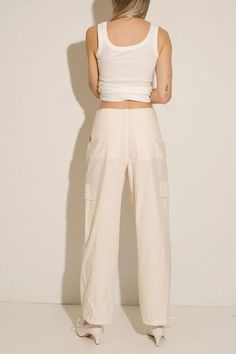 Loosely tailored cargo pant in a soft yet structured cotton. Straight leg with tie at ankle, cinch for a more tapered silhouette. Side pockets and oversized patch pockets above knee. Made in New York City. Fabric is 100% cotton. Ella is 6' tall, 35" bust, 26" waist, 36" hip, and is wearing a size S. Chic Wide Leg Cargo Pants With Flap Pockets, Cotton Cargo Jeans In Straight Fit, Chic High-waisted Cargo Pants With Flap Pockets, High Waist Cotton Cargo Pants With Multiple Pockets, Spring Straight Cargo Jeans With Multiple Pockets, Chic High-waisted Parachute Pants With Cargo Pockets, High-waist Cotton Parachute Pants With Multiple Pockets, High Waist Cotton Parachute Pants With Multiple Pockets, Spring Straight Cargo Pants With Flap Pockets