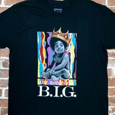 a black t - shirt with an image of a woman wearing a crown