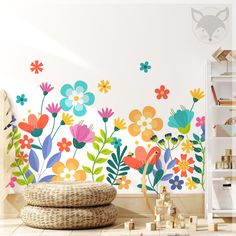 a room with flowers painted on the wall and wooden toys in the floor below it