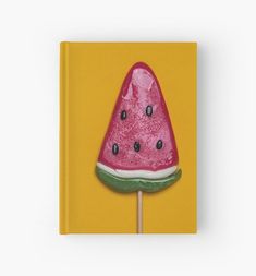 a watermelon lollipop on a yellow background