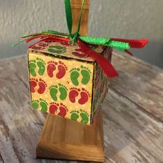 an ornament made to look like a box with foot prints on it