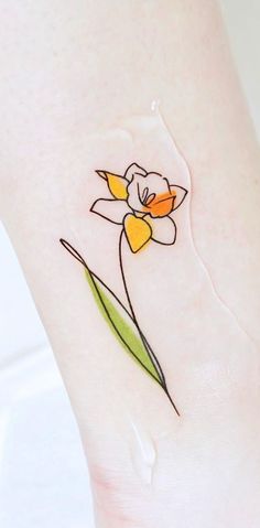 a small flower on the side of a woman's leg