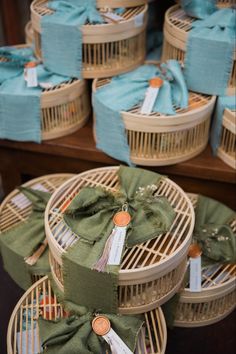 baskets with ribbons and tags are stacked on top of each other