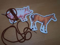 two stickers with horses on them sitting next to a cord and a pair of scissors