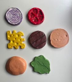 four different colored cookies sitting on top of a table