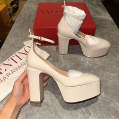 New In Box. Women’s Size 40.5. Valentino Garavani Tan Go Platform Heels. In An Ivory/Cream Color. Originally $1,200. Take Center Stage Wearing Valentino Garavani's Striking Tan-Go Pumps. Made From Patent Leather, They Rest On Staggering Platforms And Block Heels, And Fasten With Dainty Vlogo Buckled Ankle Straps. Closure: Buckle-Fastening Ankle Strap Lining: Leather Sole: Leather Insole And Sole Toe Shape: Round Toe Upper: Leather Please See Close Up Of Raised Dot On Shoe. And Marks On Bottoms Of Soles. Valentino Studded Heels, Valentino Rockstud Heels, Valentino Rockstud Pumps, Rockstud Heels, Valentino Pumps, Valentino Heels, Platform Pumps Heels, Velvet Pumps