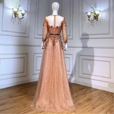 Rose Gold Elegance: The luxurious rose gold hue emanates sophistication, adding an exquisite touch to weddings and formal gatherings. Modest Long Sleeves: Long sleeves offer a blend of modesty and grace, making it perfect for women who appreciate a refined style. Arabic-Inspired Aesthetic: The gown's design draws inspiration from Arabic motifs, seamlessly blending tradition with modern elegance. Wedding Party Perfection: Tailored specifically for wedding parties, ensuring you radiate poise and b Rose Gold Evening Dress, Arabic Motifs, Muslim Gown, Gold Evening Dress, Gold Evening Dresses, Elegance Wedding, Inspired Aesthetic, Wedding Parties, Refined Style