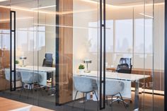 an office with glass walls and chairs