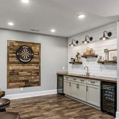 a kitchen with wood floors and white walls