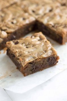 chocolate chip cookie bars cut into squares on parchment paper