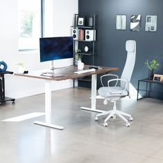 an office with a desk, chair and computer monitor on the table in front of it