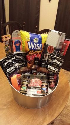 a metal bucket filled with food on top of a wooden table