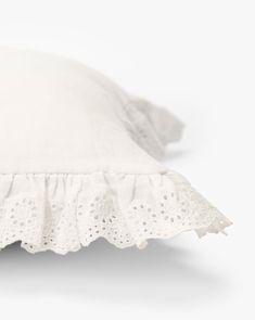 a white pillow with ruffled edges on a white background