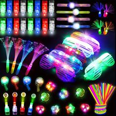 many different colored lights and accessories on a black background