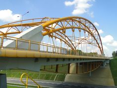 a yellow and white bridge over a road