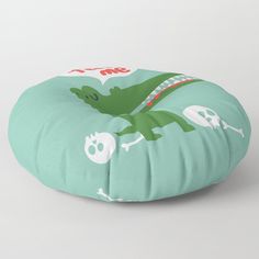 a green round floor pillow with skulls and alligators on it, sitting on a white surface