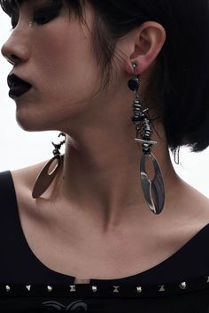 Embrace the perfect fusion of futuristic and punk aesthetics with our Mechanical Punk Metal Earrings / Ear Clips. These striking accessories feature a design composed of multiple spiral metal coils and irregular metal pieces, resembling a spiral galaxy. The bottom of each earring is adorned with a large oval metal plate, adding a bold and edgy element to the overall look. Crafted from premium materials, these earrings ensure durability and a distinctive style statement. Perfect fusion of futuris Black Metal Earrings For Alternative Fashion, Edgy Silver Earrings For Alternative Fashion, Silver Punk Earrings For Alternative Fashion, Punk Style Silver Earrings For Alternative Fashion, Edgy Earrings For Concert, Silver Punk Style Metal Earrings, Edgy Pierced Metal Earrings, Edgy Metal Earrings For Party, Edgy Metal Party Earrings