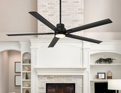 a living room with a fire place and a ceiling fan that is black in color