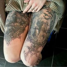 two women with tattoos on their legs sitting next to each other