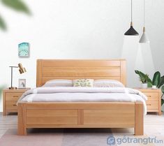 a bedroom with a bed, nightstands and potted plants