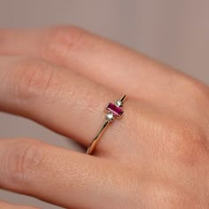 A minimalist ring with a baguette ruby in 14K solid gold and two diamonds. A stacking ring for women with natural gemstones. A great birthday gift for her. 100% handcrafted with love! * Material: 14K solid white gold, 14K yellow gold * Gemstone: Ruby, baguette cut, Diamonds, brilliant cut * Gemstones Weight: Ruby 0.17 ct, Diamonds 0.03ct * Ruby's Dimensions 4 mm x 2 mm HOW TO ORDER * Choose from the drop-down menus the available options (Ring size, Metal) and leave us a note for any special requ Ruby Ring With Baguette Diamonds For Gift, Fine Jewelry Ruby Ring With Baguette Diamonds, Ruby And Gold Ring, Gold Ring With Ruby, Ruby Gold Ring, Dainty Ruby Ring, Small Earrings Gold, Couple Ring Design, Ruby Diamond Ring