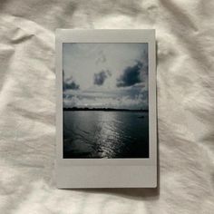 a polaroid photo sitting on top of a white sheet