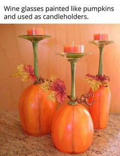 three pumpkins with candles in them sitting on a counter top next to each other