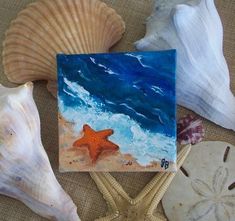 a painting of a starfish on the beach next to some shells and seashells