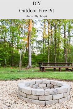 an outdoor fire pit in the middle of a park