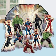 an assortment of avengers cutouts are displayed in front of a window with the image of superheros on it