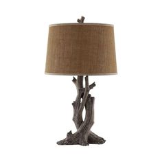 a lamp that is made out of driftwood and has a brown shade on it