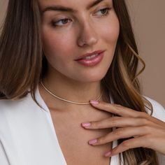 Give the gift of sparkle this holiday season with our Diamond Tennis Choker Necklace. Featuring dazzling diamond gemstones on a delicate chain, this versatile piece adds elegance to any look—from casual outings to glamorous date nights. A perfect Christmas gift to make someone shine. SKU: RR-NR152 Product Details Finish/Material: 18K Gold Over Brass ∙ Rhodium Over Brass, CZ Diamond Gemstones Featuring a Dainty ~2mm CZ Diamond Tennis Choker Necklace, available in 2 lengths: 14 Inches + 2 Inch Ext