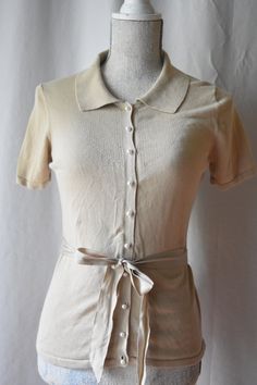 "Sophisticated and feminine, vintage, beige button up collared sweater blouse with lovely pearl buttons. With short sleeves and a nice matching sash to tie around the waist. There is some stretch to the fabric. Women's size S. Bust: 34\" Waist: 30\" Length: 23: Tag: East 5th Material: 57% cotton 43% rayon" Collared Sweater, Shirt Business, Pop Style, Collar Blouse, Casual Attire, Pearl Buttons, Sweater Blouse, Womens Clothing Tops, Business Casual