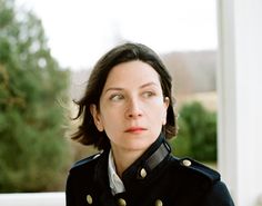 a woman in uniform looking at the camera