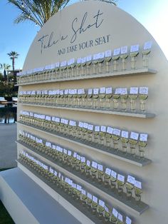 there is a sign that has wine glasses on it and place cards in front of it