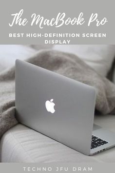 an apple laptop sitting on top of a bed with text overlay that reads, the macbook pro best high - definition screen display