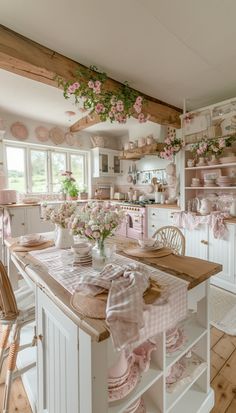 a kitchen filled with lots of pink flowers and dishes on top of a wooden table