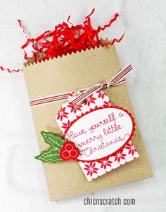 a small bag with some red ribbon on it and the tag says, have yourself a merry little christmas