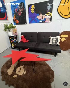 a living room filled with furniture and pictures on the wall