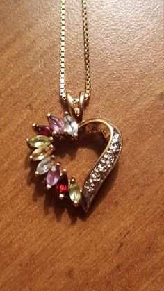 This is a gorgeous vintage sterling silver gold overlay multistone heart pendant on an Italian sterling silver gold overlay necklace. The pendant has aquamarine, amethyst,  red garnet, peridot, and citrine gemstones. The pendant and necklace are both in excellent vintage condition. The pendant measures 1 inch high by 1/2 Inch wide and the necklace measures 18 inches long. Marked Italy 925. Elegant Multicolor Birthstone Jewelry, Anniversary Costume Jewelry With Gemstones, Vintage Gemstone Heart Pendant Necklace, Fine Jewelry Gemstone Necklace Collectible, Fine Jewelry Heart-shaped Gemstone, Multicolor Hallmarked Necklace For Anniversary, Fine Jewelry Heart Shaped Gemstone, Collectible Fine Jewelry Necklaces With Gemstones, Heart Cut Gemstone Jewelry For Mother's Day