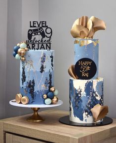 two cakes decorated with gold and blue decorations