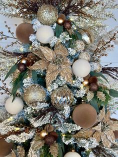 a christmas tree decorated with gold and white ornaments