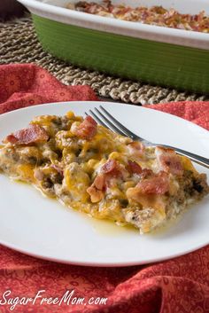 a slice of casserole on a white plate with a fork next to it