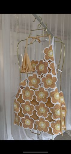 a dress hanging on a rack in front of a window